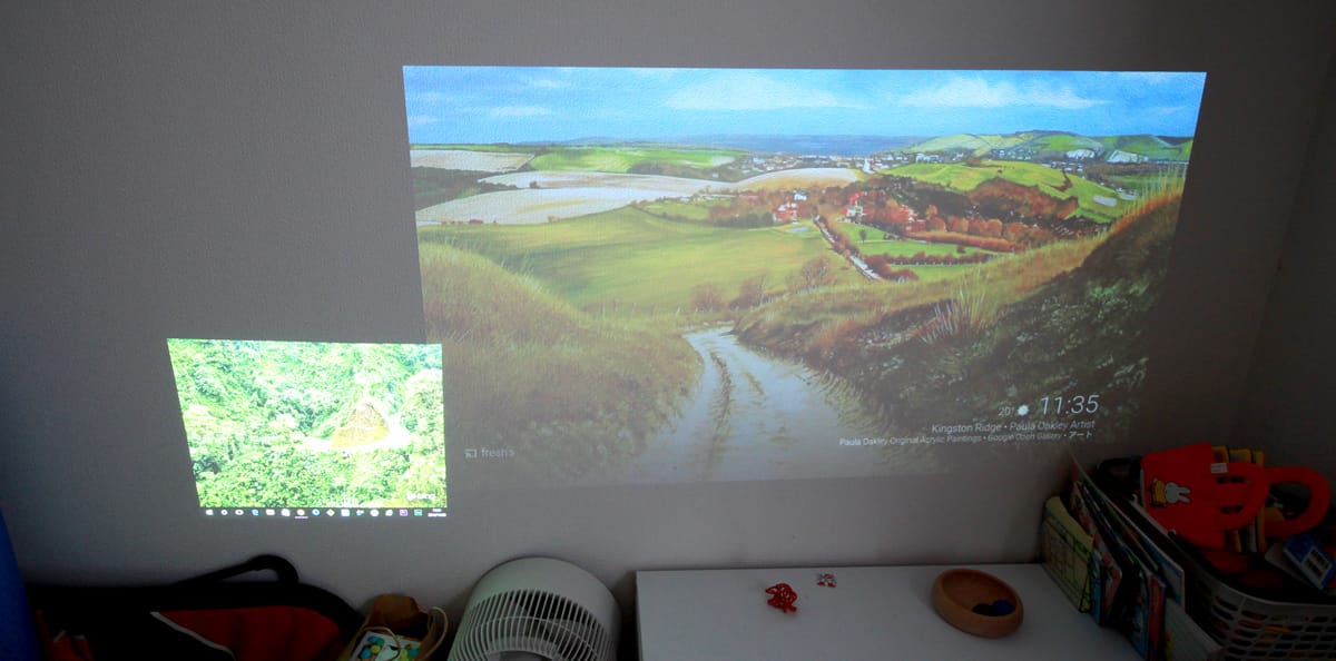 A bedroom with a computer monitor