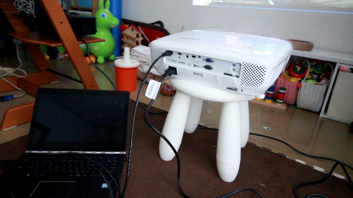 A cluttered desk with a laptop computer