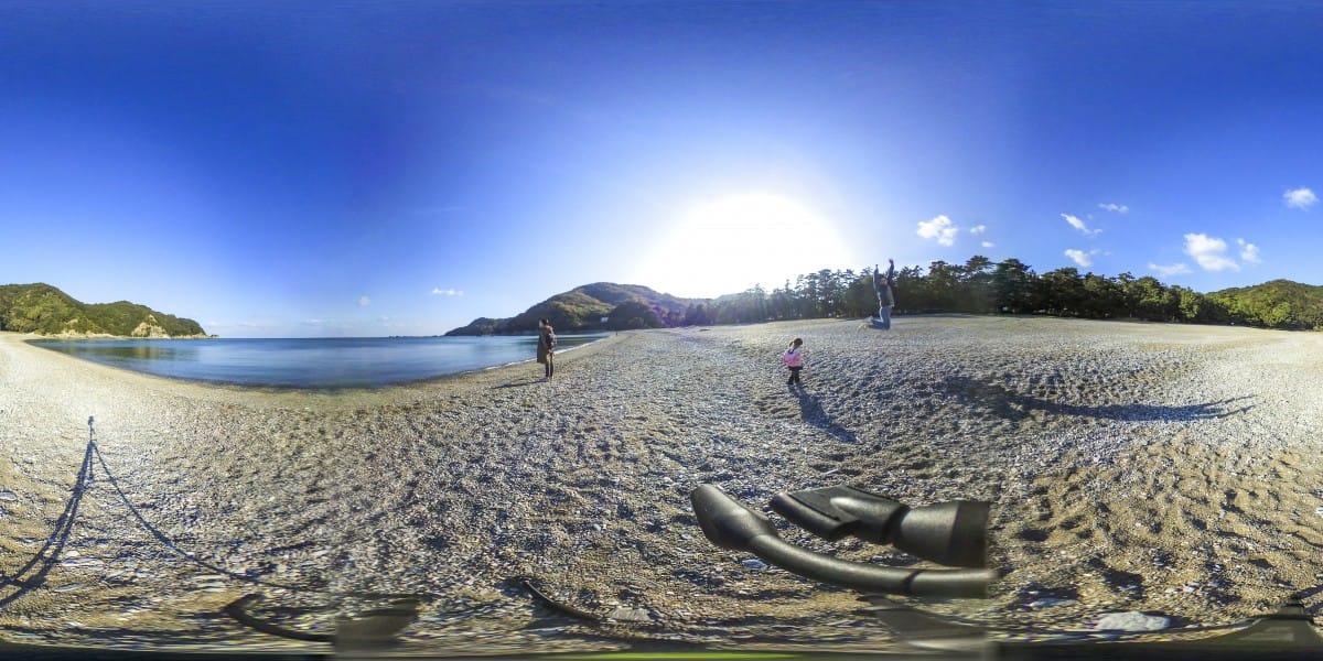 A sandy beach next to the water