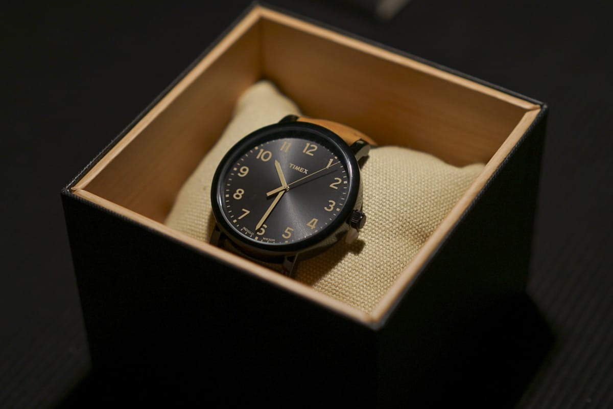 A clock sitting in front of a box