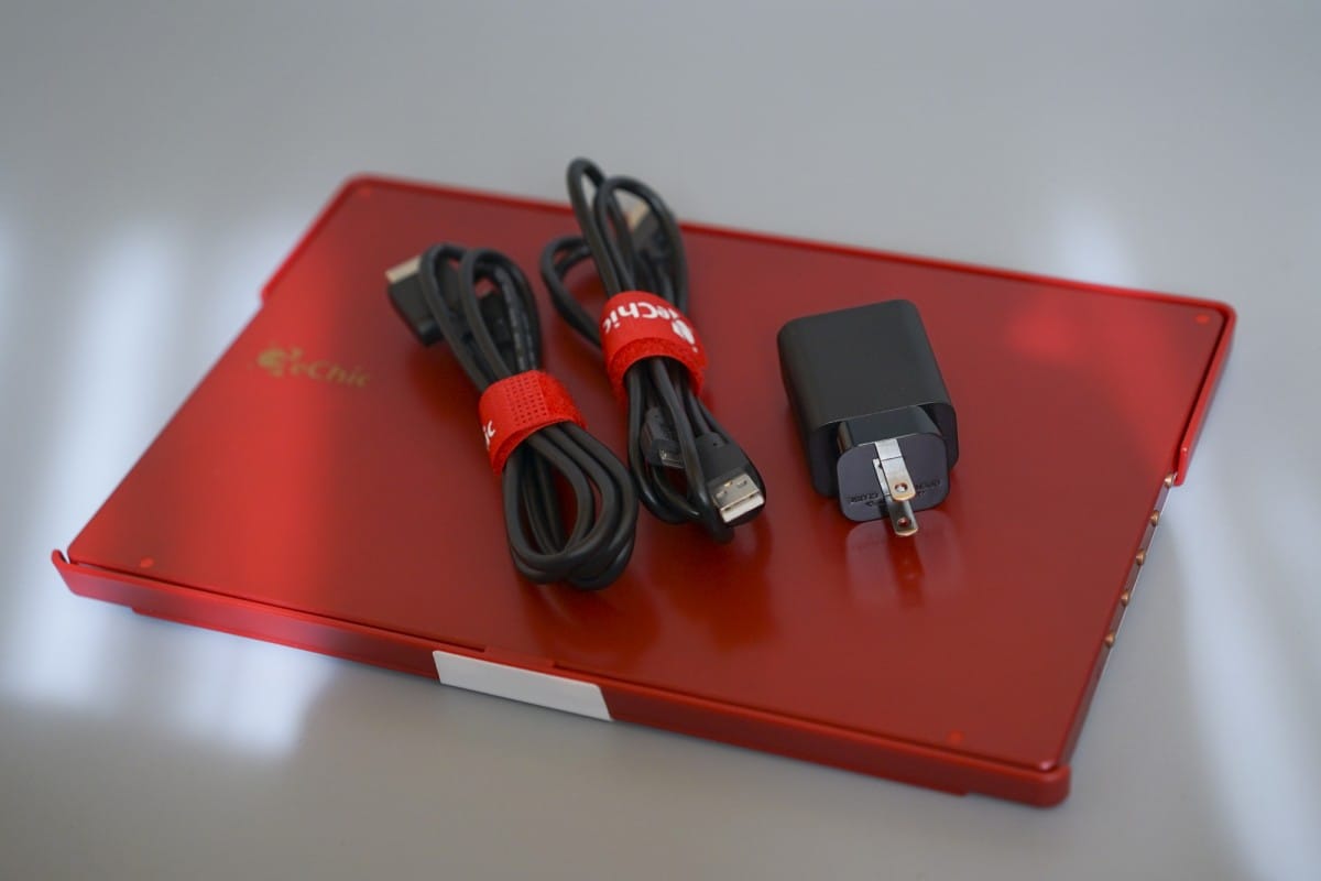 A red laptop sitting on a table