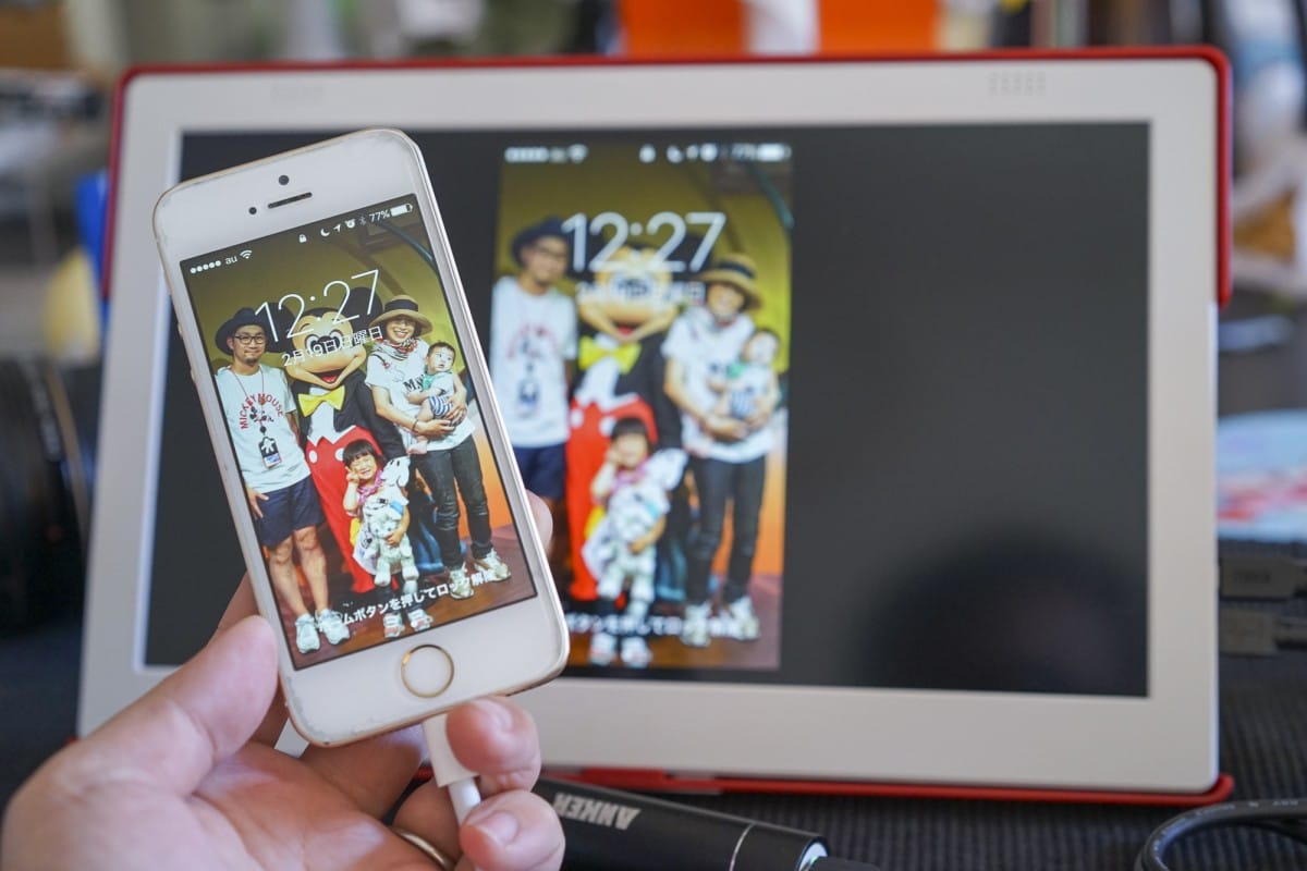 A hand holding a laptop