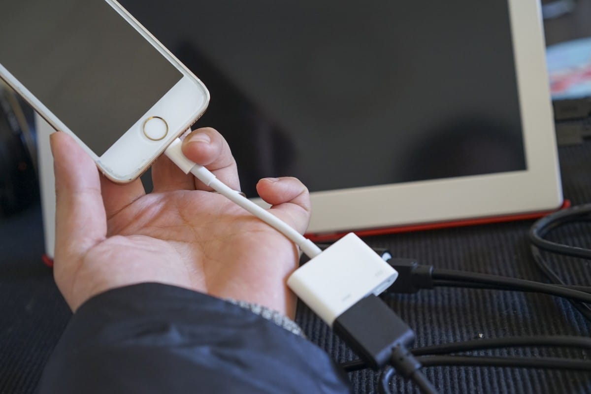 A hand holding a remote control