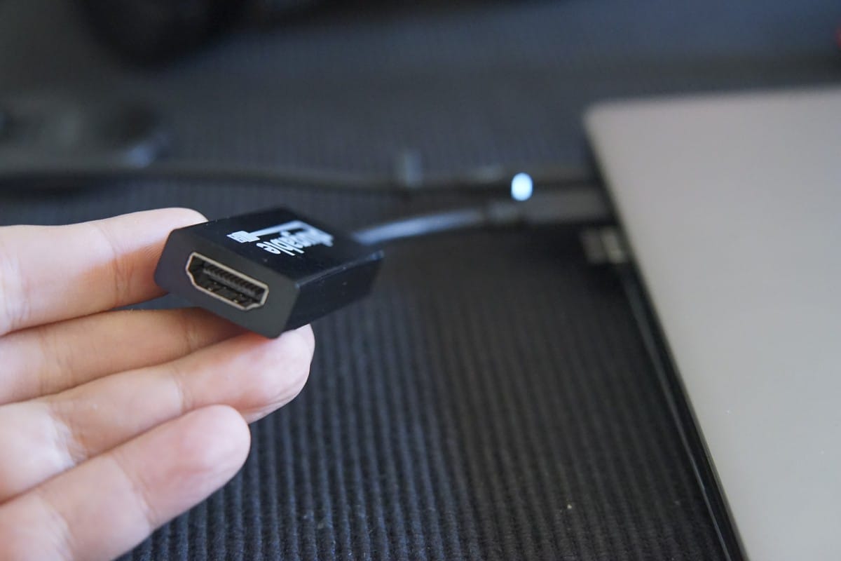 A hand holding a remote control