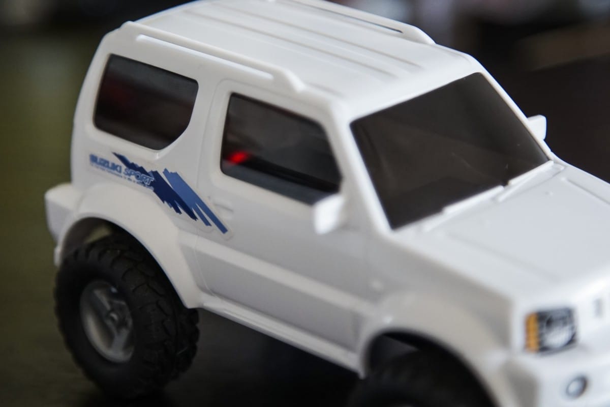 A white and black truck sitting on top of a car