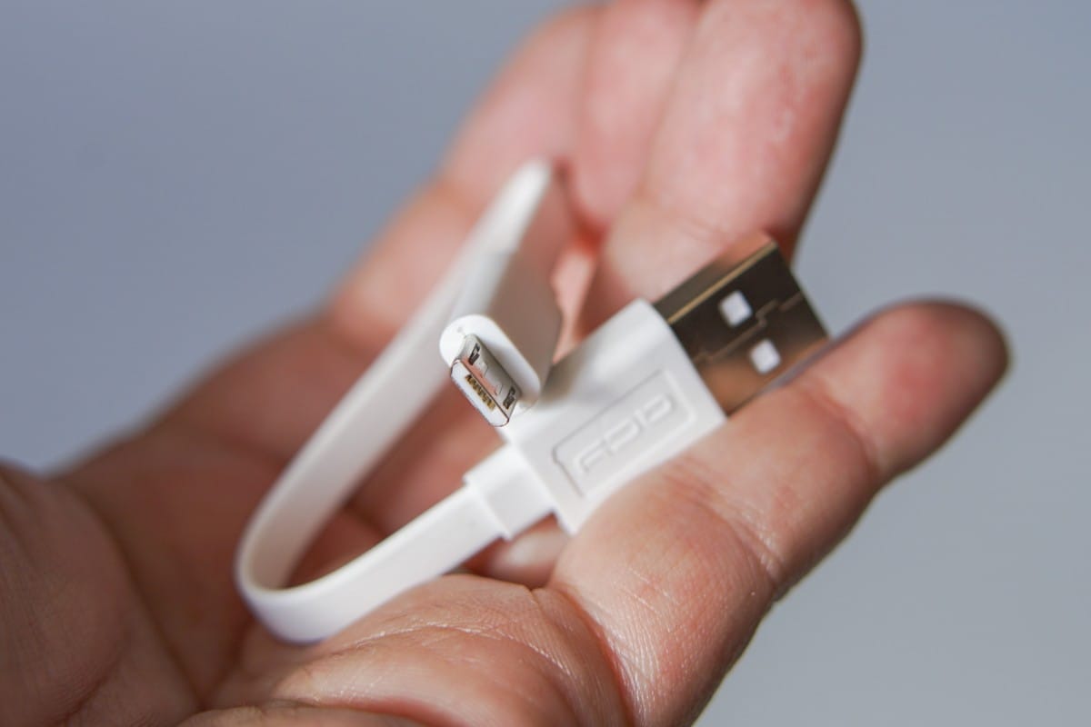 A hand holding a remote control