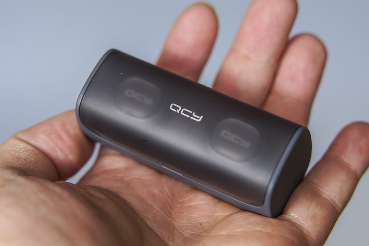 A hand holding a remote control