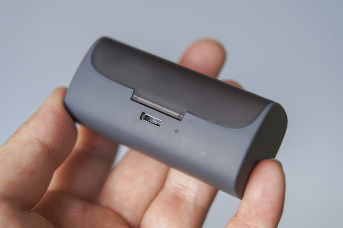 A hand holding a remote control