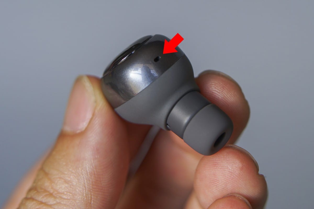 A hand holding a remote control