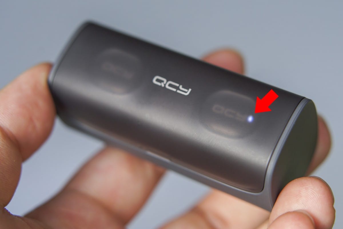 A hand holding a remote control