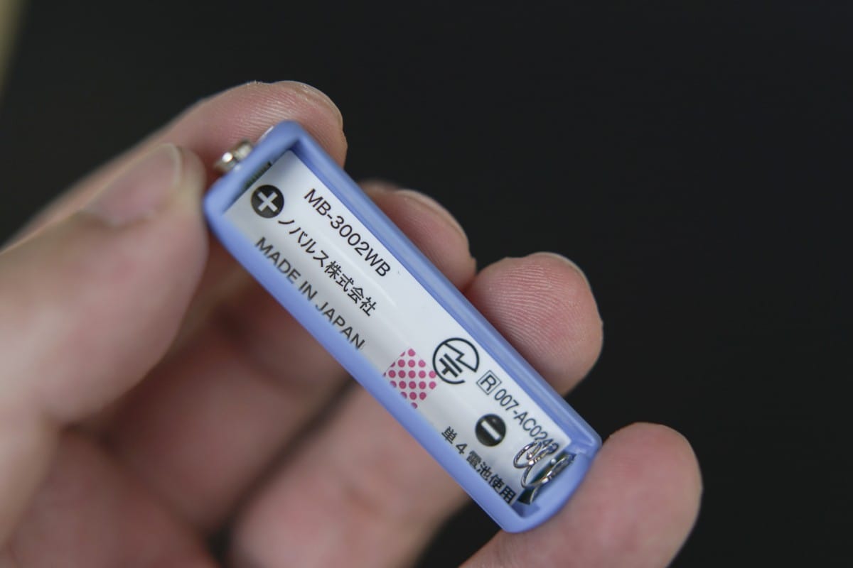 A hand holding a remote control