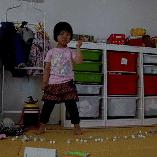A little girl standing in a room