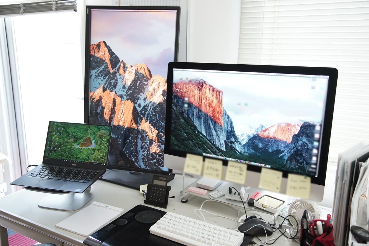 A desk with a computer monitor and keyboard