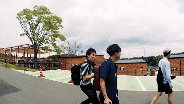 A group of people walking in a parking lot